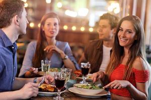Group Of Friends Enjoying Meal In Restaurant photo