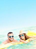 Young couple having fun in the sea photo