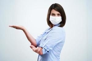 Attractive woman wearing protective mask isolated over white background photo