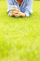 Woman with cellphone on grass photo