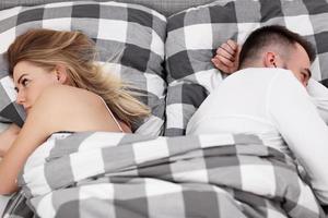 Adult attractive couple in bed having problem photo