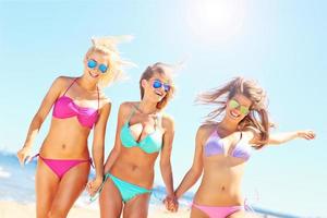 Group of women walking along the beach photo