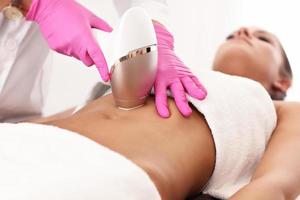 Adult woman having laser hair removal in professional beauty salon photo