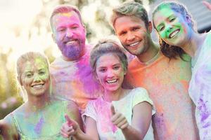 Group of friends having fun at color festival photo