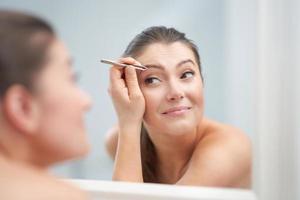 Young nice brunette woman in the bathroom photo