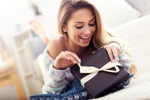 Woman lying on carpet with present photo