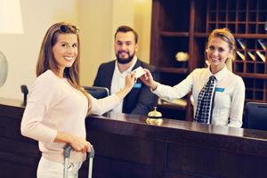 Woman at reception desk in hotel photo