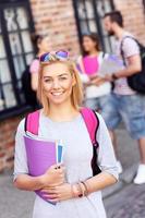 Group of happy students studying outdoors photo