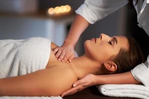 Relaxed woman receiving back massage photo