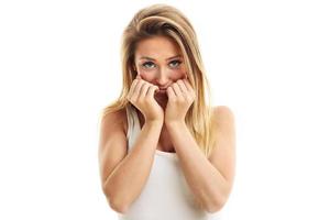 Afraid woman looking at camera isolated on a white background photo