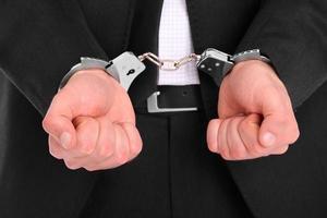 Man in suit handcuffed photo
