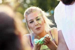 Group of friends having fun at color festival photo