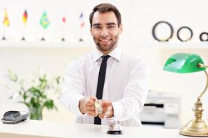 Happy receptionist working in hotel photo