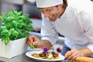 Busy chef at work in the restaurant kitchen photo