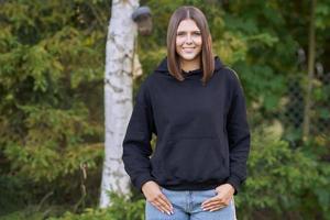 Young woman in black hoodie. photo