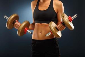 Woman lifting dumbells photo