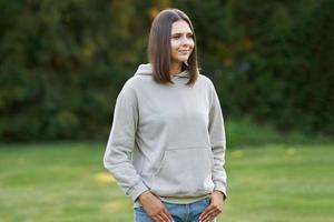 Young woman in beige hoodie. photo