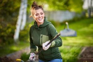 Picture of woman working with tools in the garden photo