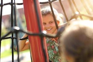 Joyful children having fun on playground photo