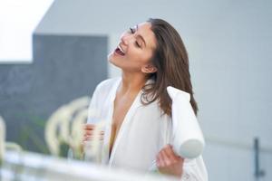 Young nice brunette woman in the bathroom haircare photo