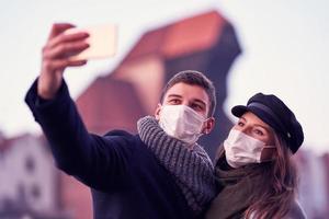 Happy couple celebrating Valentines Day in masks during covid-19 pandemic photo