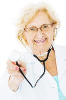 Senior Doctor Holding Stethoscope Over White Background photo