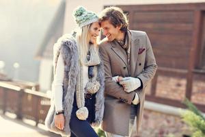 Happy couple walking outdoors in winter photo