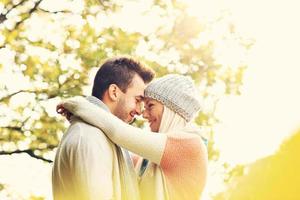 Young romantic couple in the park in autumn photo