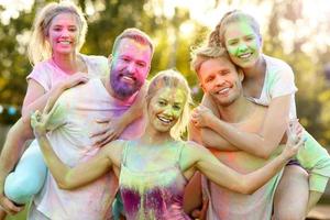 Group of friends having fun at color festival photo