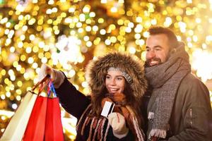 Adult couple shopping in the city during Christmas time photo