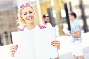 Young student standing in the campus with an open notebook photo