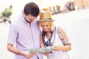 Happy tourists with a map photo