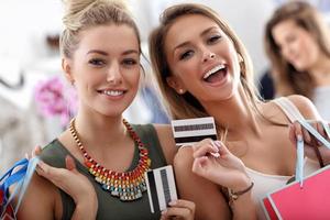 Group of happy friends shopping in store photo