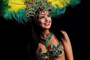 Brazilian woman posing in samba costume over black background photo