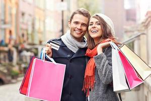 Happy couple shopping in the city photo