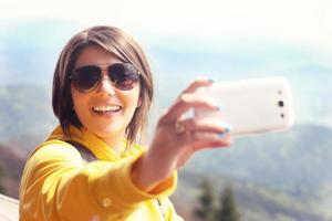 Tourist taking selfie in the mountains photo