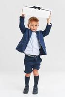 Portrait of happy cute little kid holding gift photo