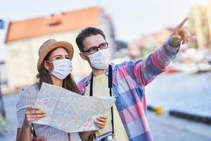 Adult tourists in masks sightseeing Gdansk Poland photo