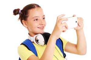 Schoolgirl taking pictures with her smartphone photo