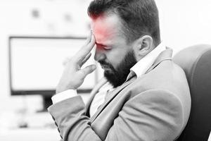 Businessman suffering from headache photo