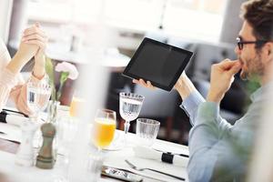 Two Businesspeople Meeting For Lunch In Restaurant photo