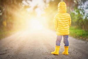 Happy child boy playing outside in autumn photo