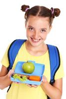 Schoolgirl with healthy lunchbox photo