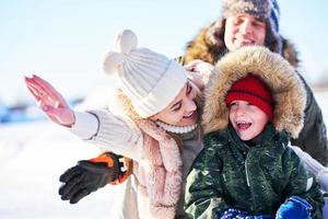 Nice happy family having fun on winter snow photo