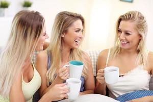 Three beautiful young women chilling at home photo