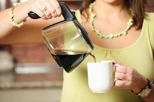 Woman pouring coffee photo