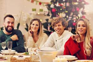 Group of family and friends celebrating Christmas dinner photo