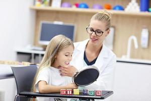 Cute little girl at speech therapist office photo