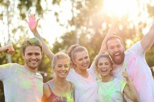 Group of friends having fun at color festival photo
