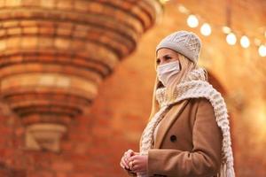 Woman wearing face mask because of Air pollution or virus epidemic in the city photo